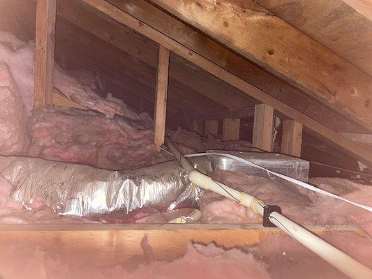 Photo #1 cramped attic and note use of CPVC (same as new construction), clamps used to every possible joist or wall. Notice piping routed ab