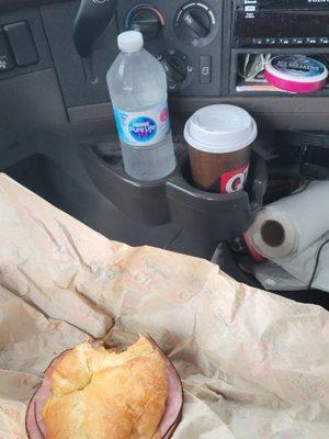 fresh ham egg and cheese croissant, bottle of water for the pills cup of coffee and some grape icebreakers never seen those