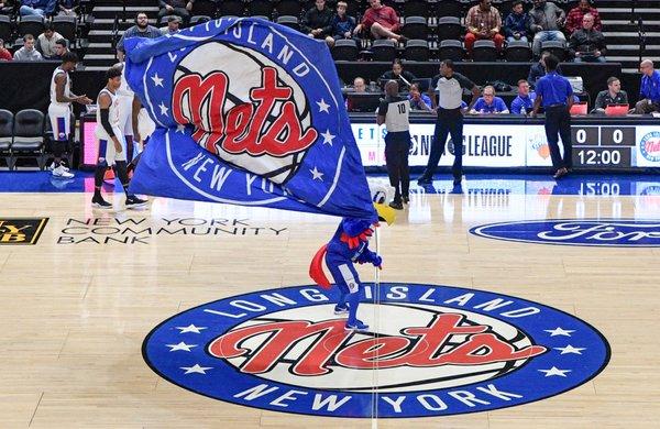 Long Island Nets center court with mascot and logo flag.