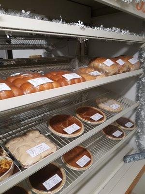 A shelf full of various baked goods.