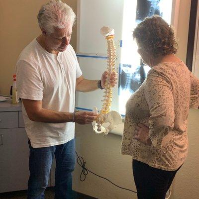 Dr. Cook walking a patient through their customized chiropractic treatment plan