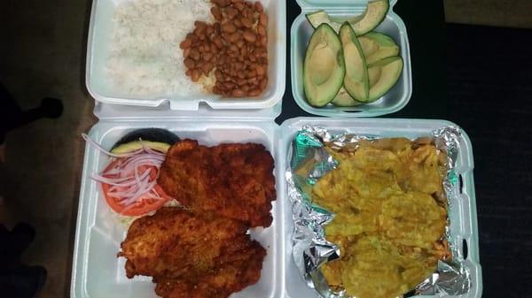 ,pollo apanado, breaded fried chicken with tostones and of course my avocados is served with a side of rice ,beans and salad..