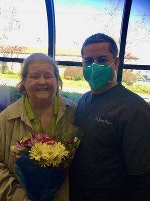 Dr. Reeves, Dr. Albert and Dr. Vergel give smiles and flowers