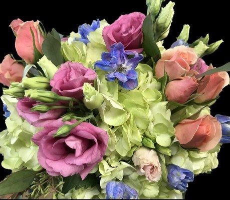 Green hydrangeas, pink lizzy, peach spray roses blue delf.