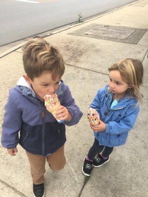 Grandkids eating a cone with sprinkles