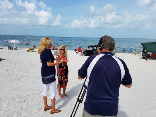 Tropics Real Estate owner Marlene Graham (left) doing a video on the history of Vanderbilt Beach