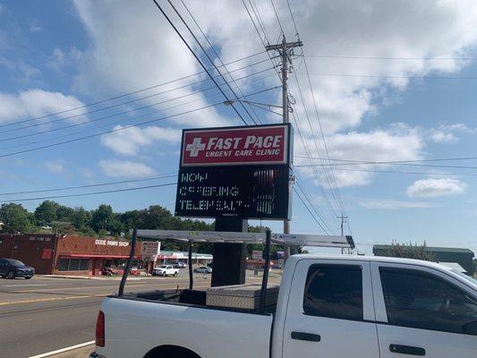 Fast pace urgent care sign near Road