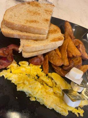 Scrambled eggs, bacon, home fries and sourdough toast