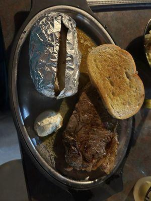 NY Strip backed potato, Gouda cheese and garlic toast.