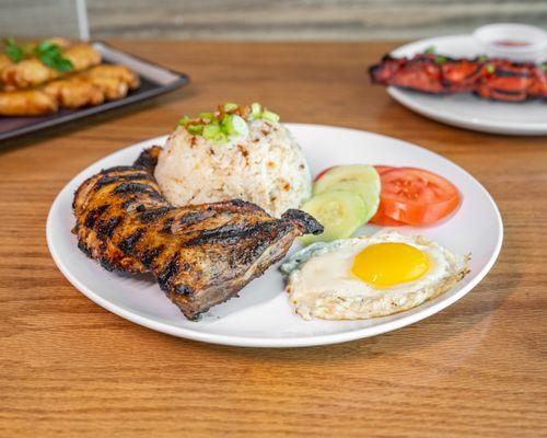 Chicken Inasal with garlic rice & eggs cooked to order with tomato and cucumber.