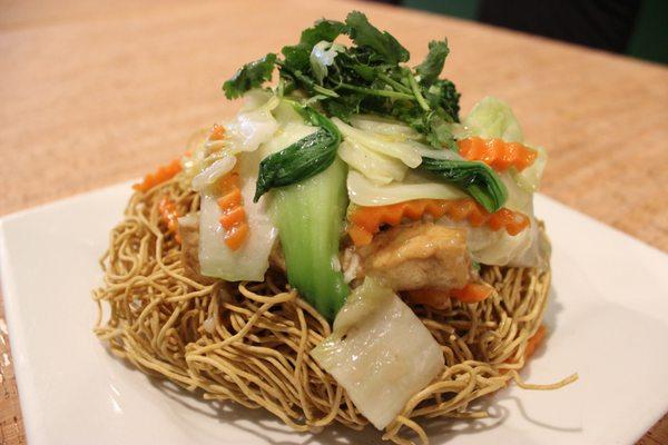 Crispy Vegan Seafood Noodles made with vegan shrimp, tofu and mixed veggies in a delectable sauce poured over crispy wheat noodles.