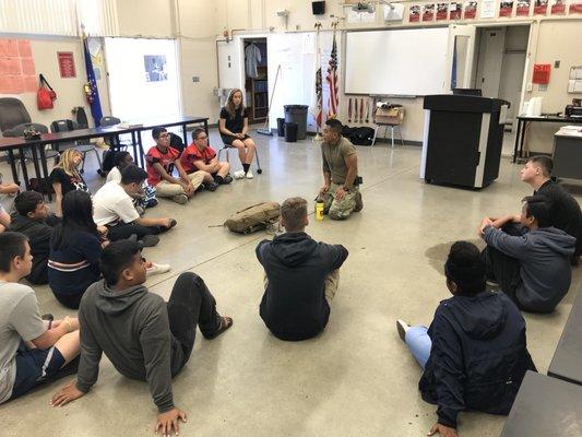 Staff Sergeant Quitugua giving a class on first aid for Cordova High School JROTC.