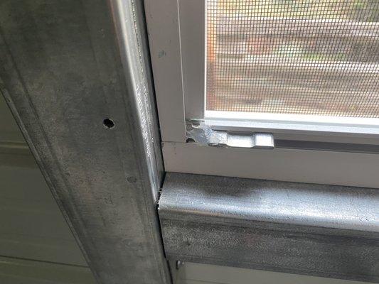 Broken tab that opens the window left side. Contractor tried to put caulking on it. contractor saw it was broken and still installed it