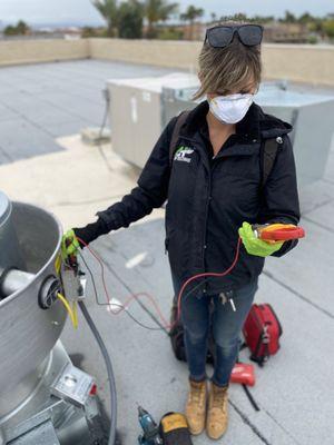 Alex checking the electrical characteristics to ensure they are in range during this Commercial Air Balance.