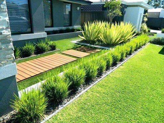 We installed the wooden walkway, gravel bed and all plants along front of house to complete our client's modern aesthetic