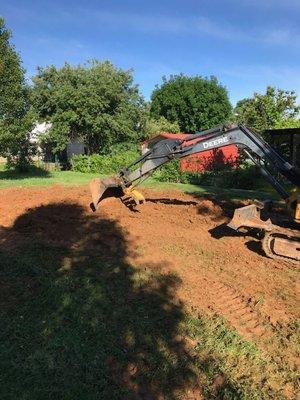 Me cutting some dirt for a swimming pool