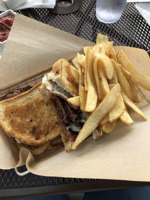 Brisket sandwich with fries.