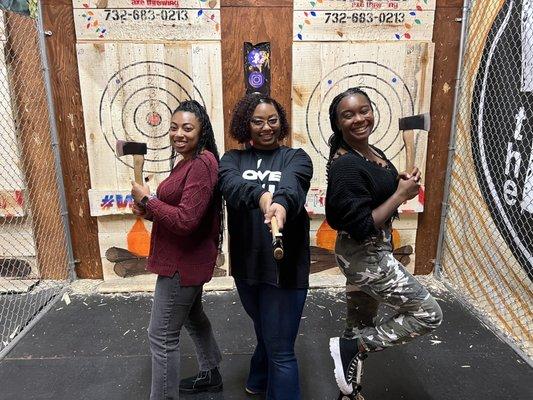 Group photo in axe throwing pit.