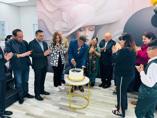 Mayor cutting cake for grand opening