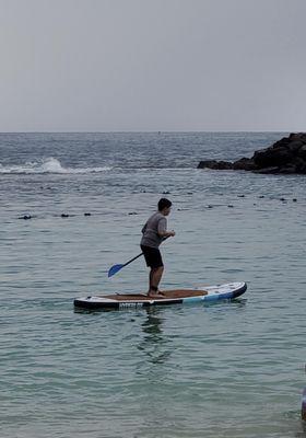 My son stand up paddle boarding