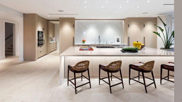 Custom kitchen by JR Builders using white oak cabinetry and marble countertops.