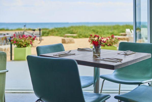 Seating overlooks the bay and on warm weather days is open to the outside weather