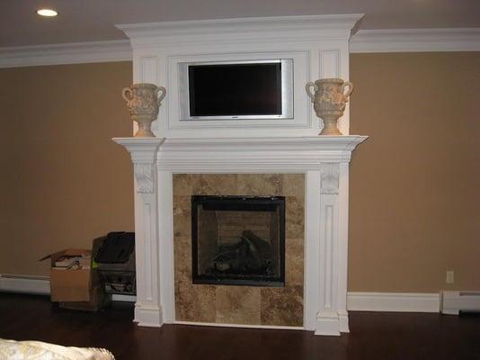 This flat panel TV was mounted above a gas fireplace. All source components were installed inside the master closet.