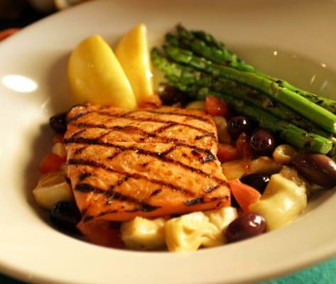 Salmon Compote - grilled salmon served over a light mix of kalamata olives, tomatoes, asparagus & artichoke hearts