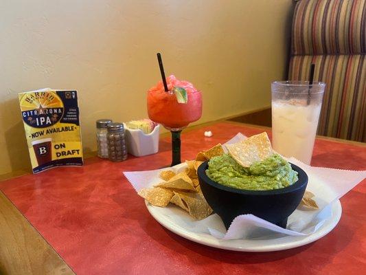 Chips, guacamole, strawberry margarita and a horchata.