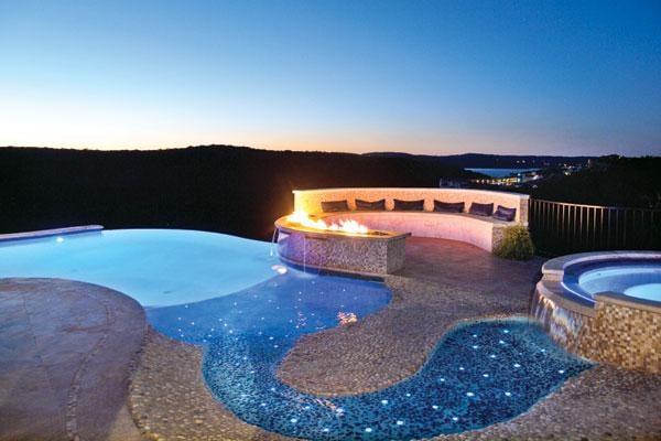 Early evening picture of a vanishing edge pool with star glow fiber optic lighting in the baja ledge. 