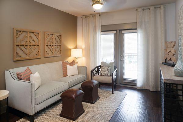 Living room with wood flooring, ceiling fan, and French doors to patio