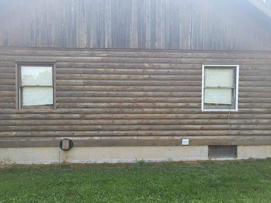 Sanding and staining a log cabin