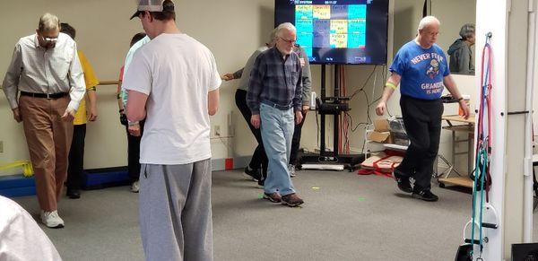 Seniors exercise with heart rate monitors and step counters to gauge their effort.