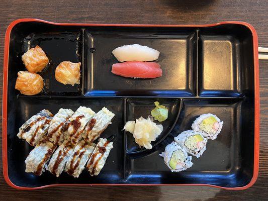 Lunch bento box: Shumai, white tuna & salmon, California roll, Godzilla roll