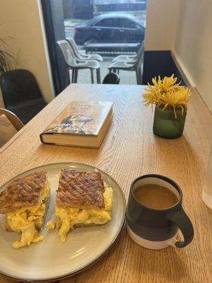 Scrambled eggs sandwich with avocado, drip coffee