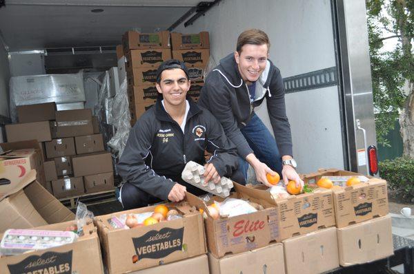 Volunteers sorting food for Basket of Miracles, a delivery program that provides food, home goods and seasonal gifts to families in need.