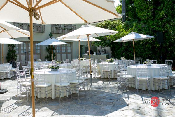 Our Clear Chiavari Chairs  with patio umbrellas and round tables. Beverly Hills ca
 cpgtentsandevents.com