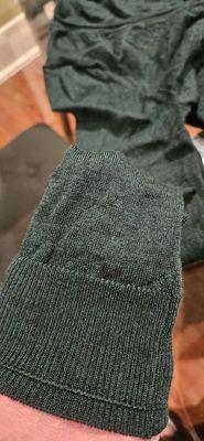 Repair of hole in forest green merino wool sweater. You can't tell unless you look closely or flip inside out.