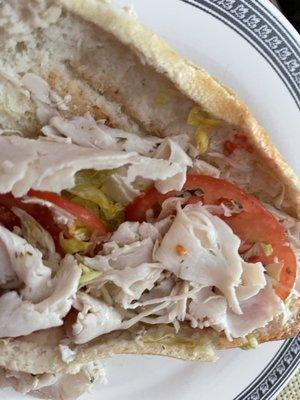 Find the sliver of cheese on a turkey and cheese hoagie