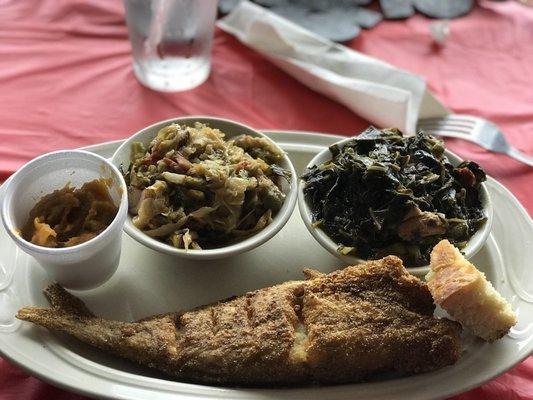 Whole fried catfish with cabbage, greens, and sweet potato pie.