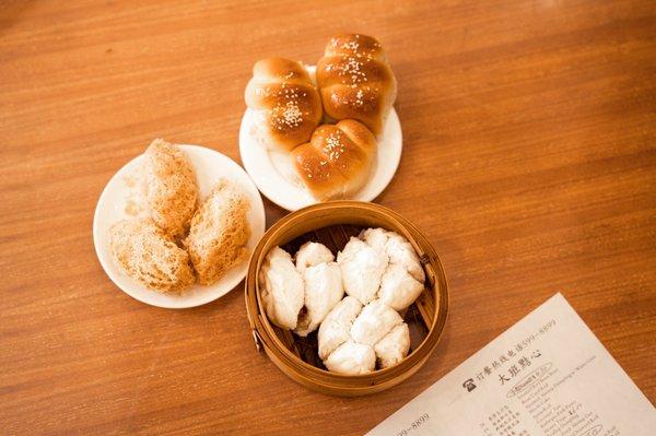 From left to clockwise: taro gok (or taro puff), hot dog buns & char siu (or pork) buns (also known locally as manapua)