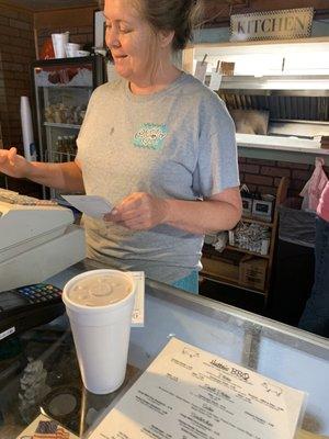 Nice lady, cash register, and kitchen