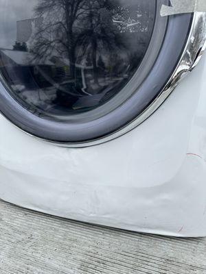 Banged up washer #1 with a door that won't close