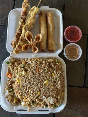 Chicken fried rice, egg rolls, chicken on a stick, sweet and sour and spicy sauces