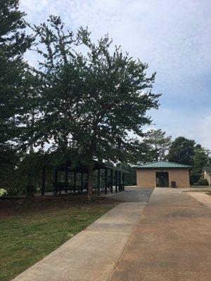 Small covered picnic area with restroom facility on the right