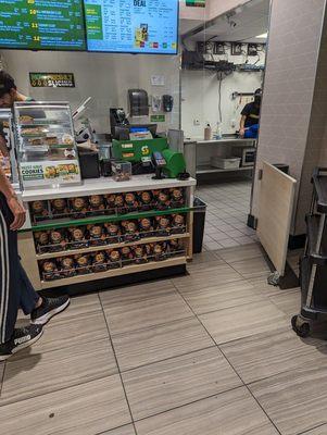 Employee sitting on the back table rubbing his barefoot.