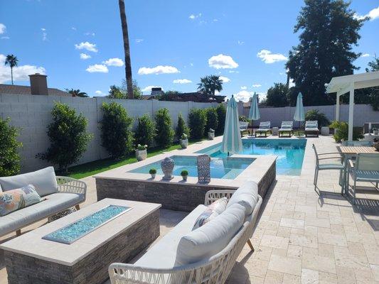 This beautiful backyard is built for entertaining with a pool, spa, and waterfall..plus expanses of beautiful travertine decking.