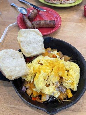 Sausage and gravy skillet with a side of sausage links.