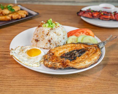 Bangus silog with garlic rice & eggs cooked to order with tomato and cucumber.