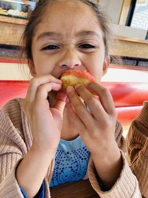 Customers enjoying strawberry iced donut with sprinkles